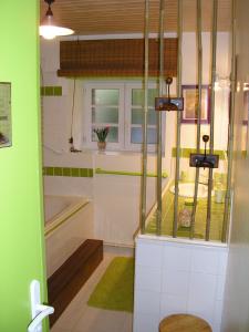a small bathroom with a tub and a sink at la Belle Epoque in Sevremont