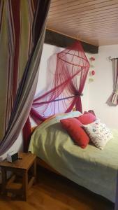 a bedroom with a bed with a net on it at la Belle Epoque in Sevremont