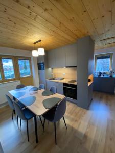 a kitchen and dining room with a table and chairs at Chata Petra in Oravský Biely Potok