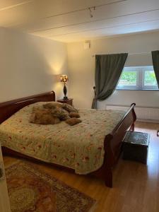 a bedroom with a bed with a stuffed animal on it at Mysig lägenhet med villakänsla in Gothenburg