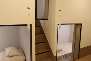 Postel nebo postele na pokoji v ubytování HOTEL minimumms女性専用カプセルホテルWomen only hotel