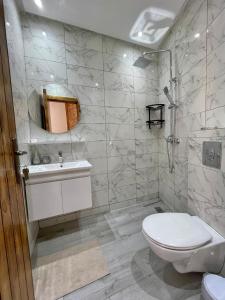 a bathroom with a toilet and a sink at Villa Luna Marrakech in El Mers