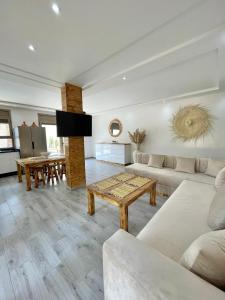 a living room with a couch and a table at Villa Luna Marrakech in El Mers