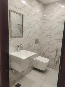 a white bathroom with a sink and a toilet at Hotel G-3 in Jalandhar +12 photos