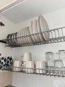 a shelf with plates and cups and dishes on it at El Descanso de Rocinante in Almagro