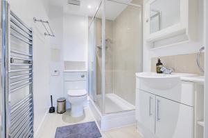 a bathroom with a shower and a toilet and a sink at Newly furnished stunning 2 bedroom flat in Colindale