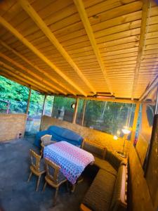 a living room with a table and a couch at Cabană B&M in Slănic-Moldova