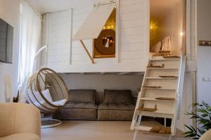 a living room with a loft bed and a couch at Casamea - Apt Spacieux, Clim, Famille & Cabane in Ajaccio +10 photos