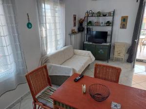a living room with a couch and a table at Marilena Apartments Plataria in Plataria