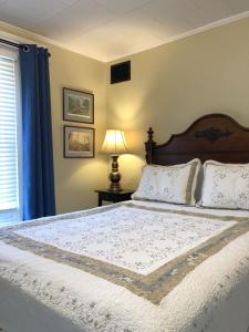 a bedroom with a bed and a lamp and a window at The Vine Bed & Breakfast, LLC in Dundee +40 photos
