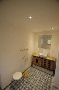 a bathroom with a sink and a mirror at Ferienhaus Nordische Ruhe in Kaiser Wilhelm Koog +32 photos