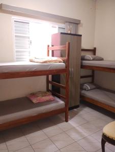 Ένα ή περισσότερα κρεβάτια σε δωμάτιο στο Casa de hospedagem Ave Maria - Eva