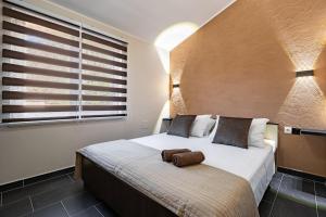 Posteľ alebo postele v izbe v ubytovaní D&A Apartments