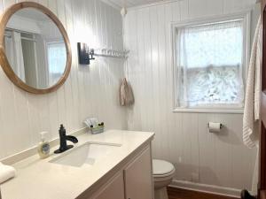 a bathroom with a sink and a toilet and a mirror at Cottage 11 - 1 Bed / 1 Bath w/ Private Courtyard in Wolfeboro
