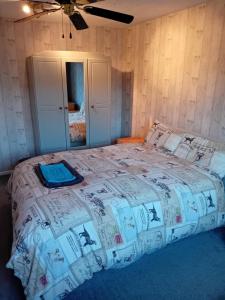 a bedroom with a bed with a comforter on it at Family room in Broadstone