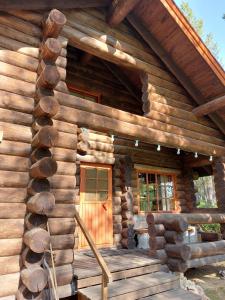a log cabin with a porch and a door at Villa Tammukka in Inari