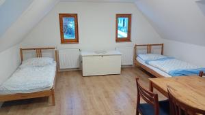 A bed or beds in a room at Chalupa U Kurišky