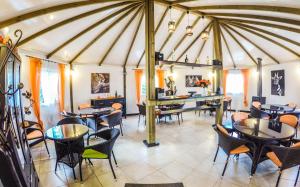 a dining room with tables and chairs in a tent at Pensión Los Caballos in Els Poblets