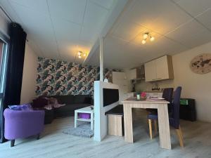 a living room with a table and a couch at FeWo Auszeit in Rieden +6 photos