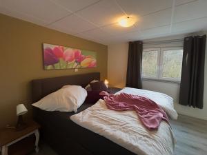 a bedroom with a bed with two pillows at FeWo Auszeit in Rieden