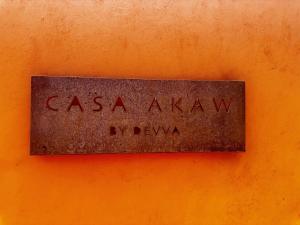 a metal sign that reads casa aaxlaw on an orange wall at La Paz Perfecta a Playa Saladita in Temalhuacán