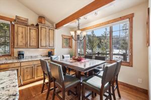 a kitchen with a dining room table and chairs at The Beaver Lodge at Breckenridge home in Breckenridge +48 photos