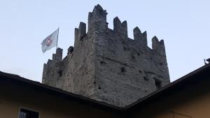 a castle with a flag on top of a building at L'Alcova dei Sogni in San Giorio