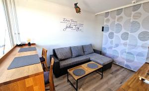 a living room with a couch and a table at Brockenblick in Altenau