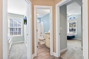 a bathroom with a toilet and a sink at Coastal Pet Friendly Getaway in Murrels Inlet! Perfect for 8 Guests! in Myrtle Beach +33 photos