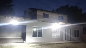 a house lit up at night with lights at Dabra in Mar de Ajó