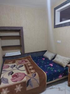 ティーズニートにあるAppartement a louer MASSINIの小さなベッドルーム(毛布付きのベッド付)