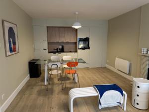a kitchen with a table and chairs in a room at Le Pantone in Neufchâteau +7 photos