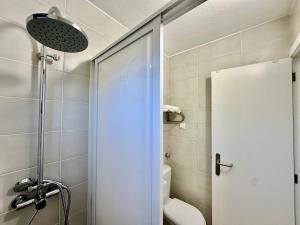 a bathroom with a shower with a toilet and a shower at Casa do Perestrelo - Guest House in Machico