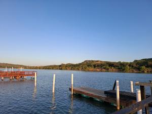 a dock in the middle of a body of water at Addo River Den in Gqeberha