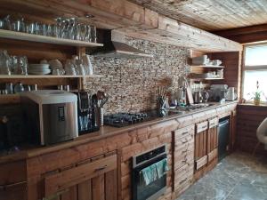 a kitchen with wooden cabinets and a counter top at Beskiden Prime Exclusiv Chalets in Prostřední Bečva
