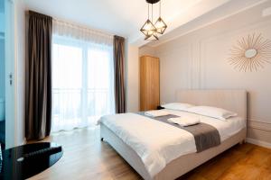 a bedroom with a bed and a large window at Complex turistic Veverita in Ranca +49 photos