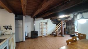 a kitchen with a stove and a refrigerator in a room at Casa La Parra in Villar de Vildas +17 photos