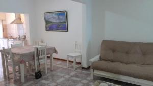 a living room with a table and a couch at Alojamiento familiar Bolivar in Gualeguaychú +1 photo