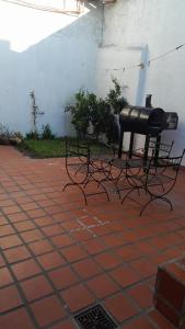 a couple of benches sitting on a brick floor at Alojamiento familiar Bolivar in Gualeguaychú