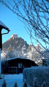 a snow covered mountain with a house in the foreground at Stylisches Design-Apartment in Rottenmann