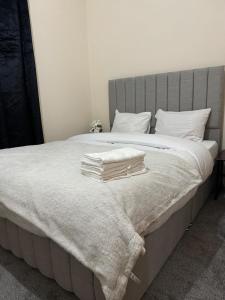 un letto con coperte e cuscini bianchi di 2 Bed Apartment city centre a Wolverhampton