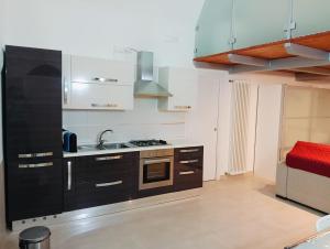 a kitchen with a sink and a stove top oven at Casa Vacanza Martino in Matera