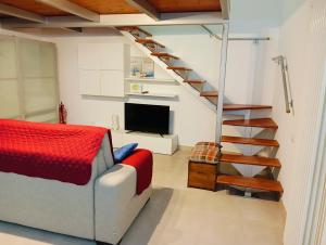 a living room with a couch and a staircase at Casa Vacanza Martino in Matera