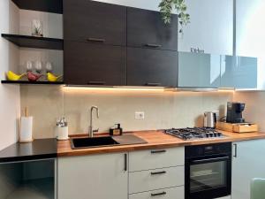 a kitchen with a sink and a stove top oven at Dimora Sangallo in Caprarola