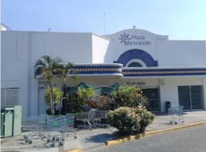 a building with chairs and trees in front of it at Hotel Albatros Palace - Bungalow G in Manzanillo