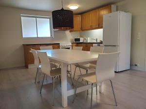 a kitchen with a white table and white chairs at Beautiful Central Apartmant in Strand