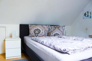 a bed in a room with a white dresser at Studio an der Ilmenau in Lüneburg