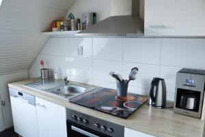 a kitchen with a sink and a counter top at Studio an der Ilmenau in Lüneburg