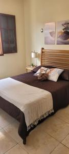 a bedroom with a large bed with a blanket at Recanto do mar e da lagoa in Arraial do Cabo