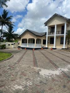 a house with a brick driveway in front of it at Jefes Haven in Dar es Salaam